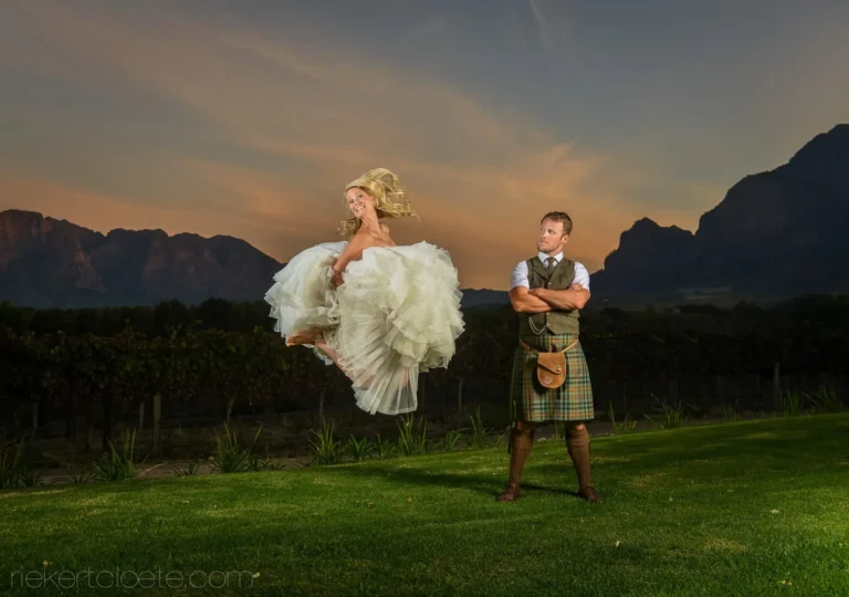 bride jumping groom kilt vineyard sunset mountains