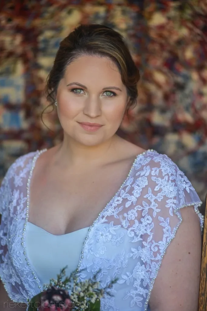 bride lace cap sleeve gown tapestry backdrop bouquet