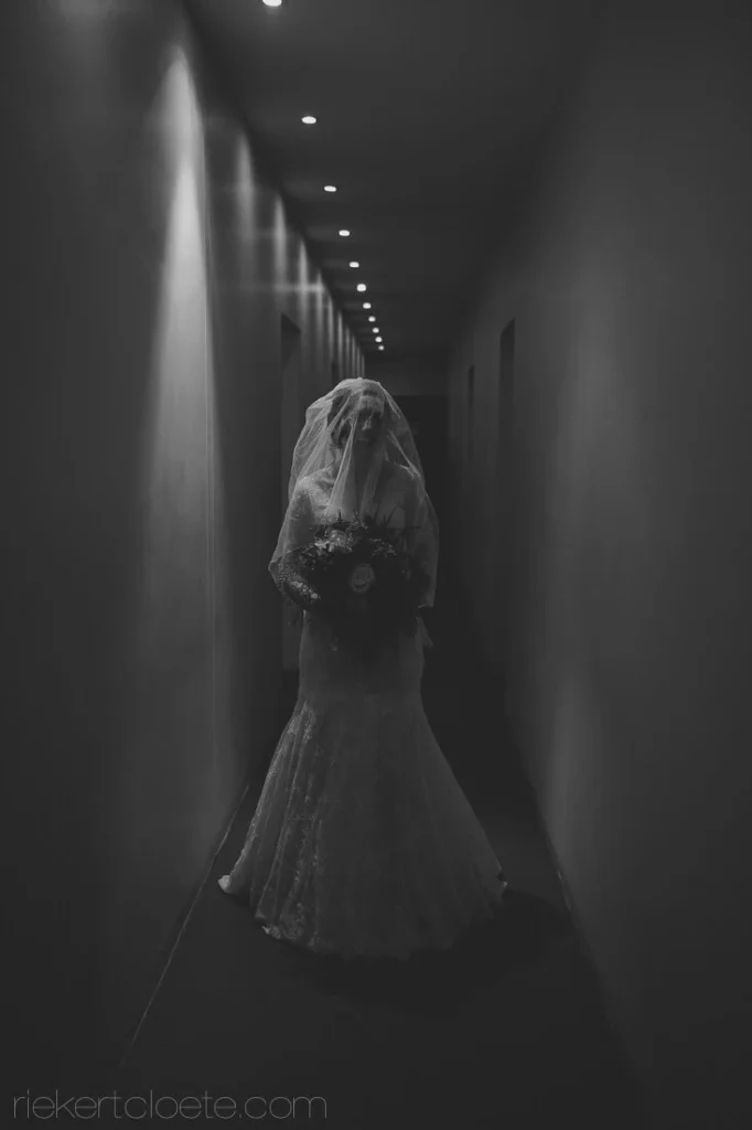 bride lace gown corridor dramatic lighting black white