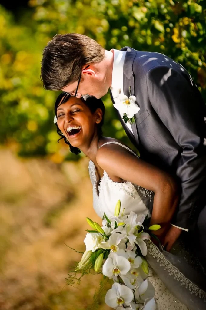 bride laughing orchid bouquet lanzerac vineyard