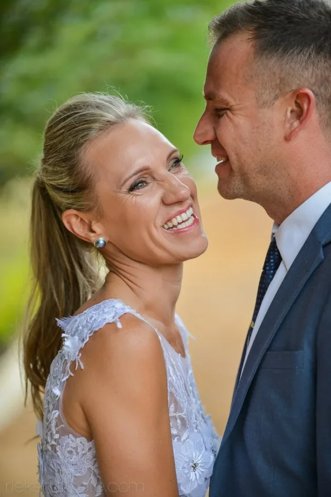 close up smiling couple portrait lace gown