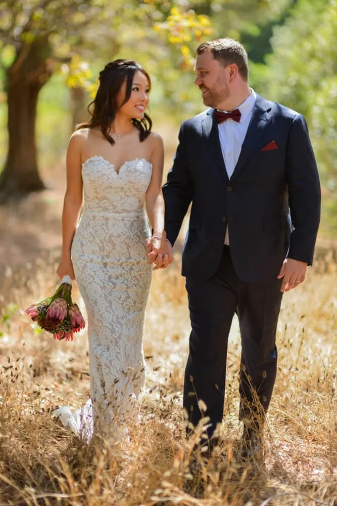 couple autumn dry grass lace gown protea bouquet