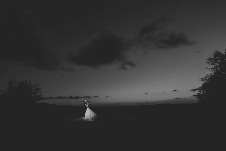 couple black white open field dusk kiss