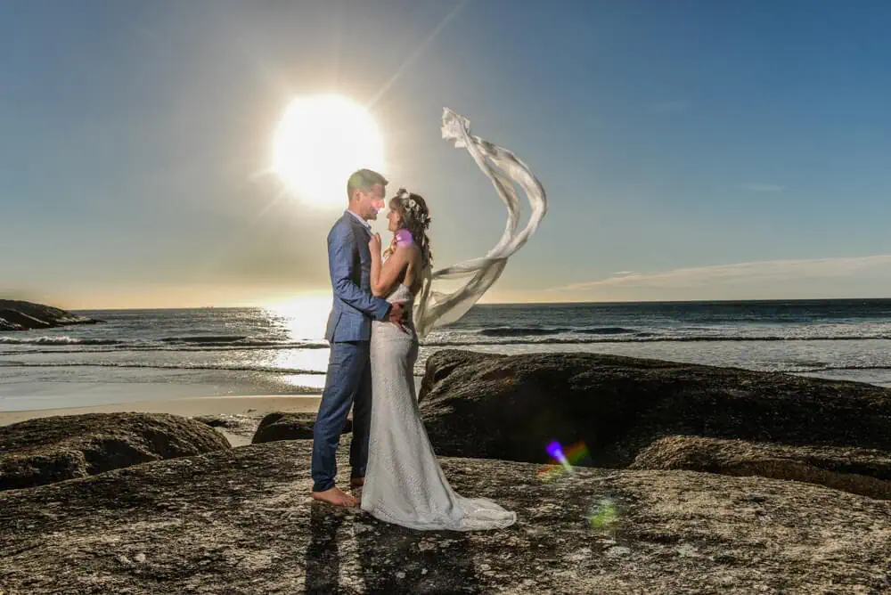 couple coastal rocks veil blowing sunset