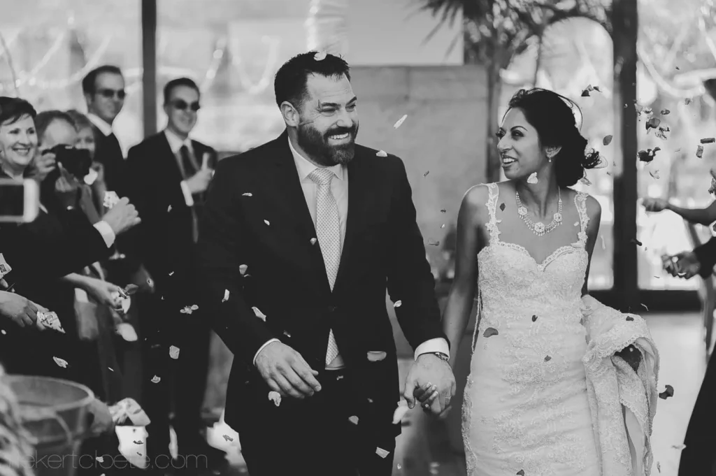 couple confetti petals smiling ceremony exit bearded