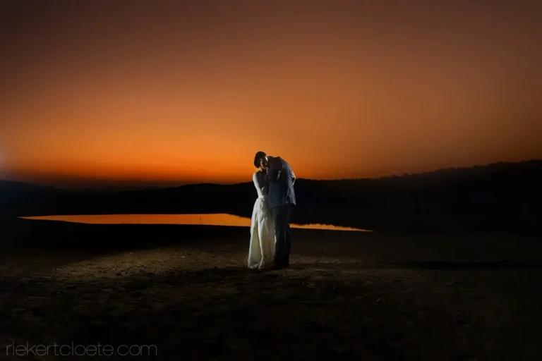 couple dam fiery orange afterglow night reflection