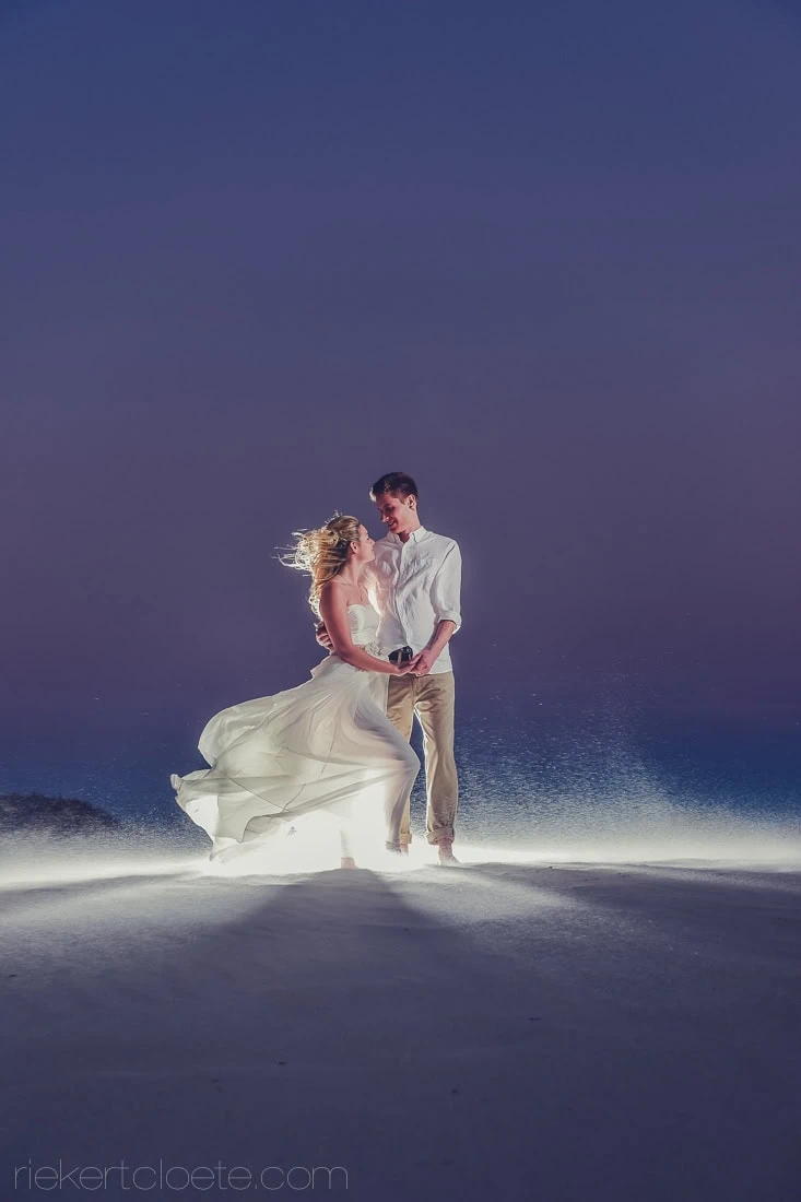couple dancing beach night backlit gown flowing