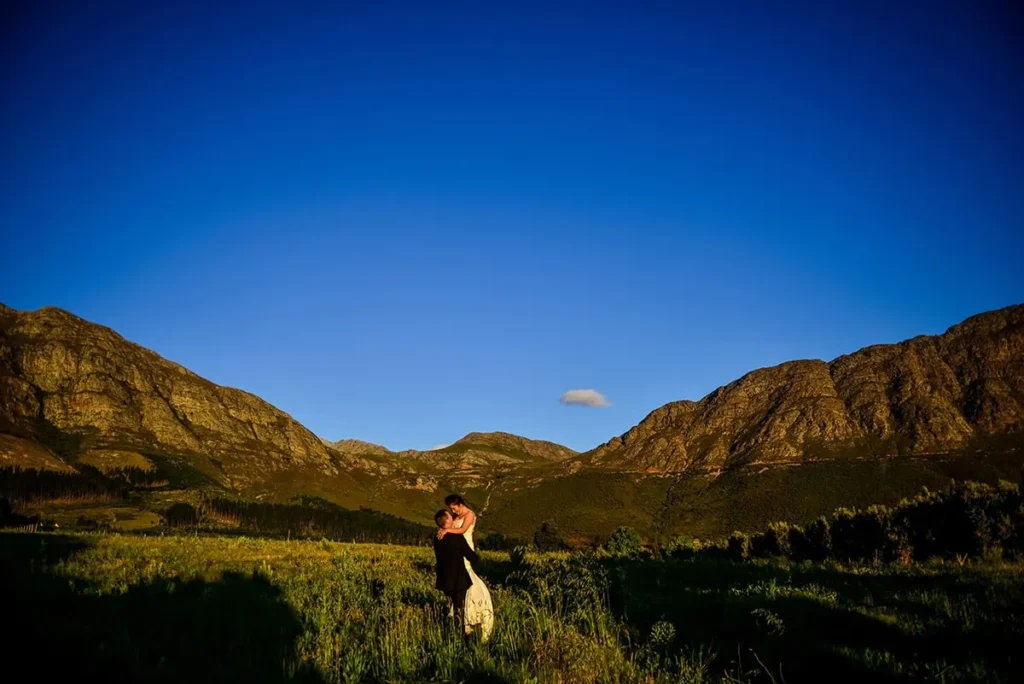 couple dancing green mountain valley golden light