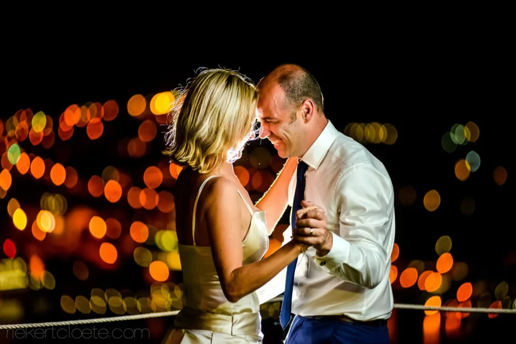 couple dancing laughing night city lights harbour