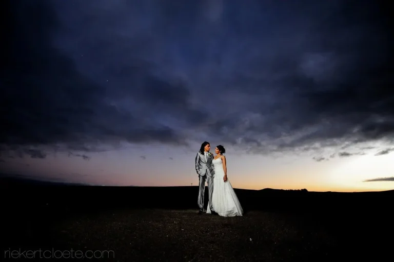 couple dramatic night sky dusk glow open field