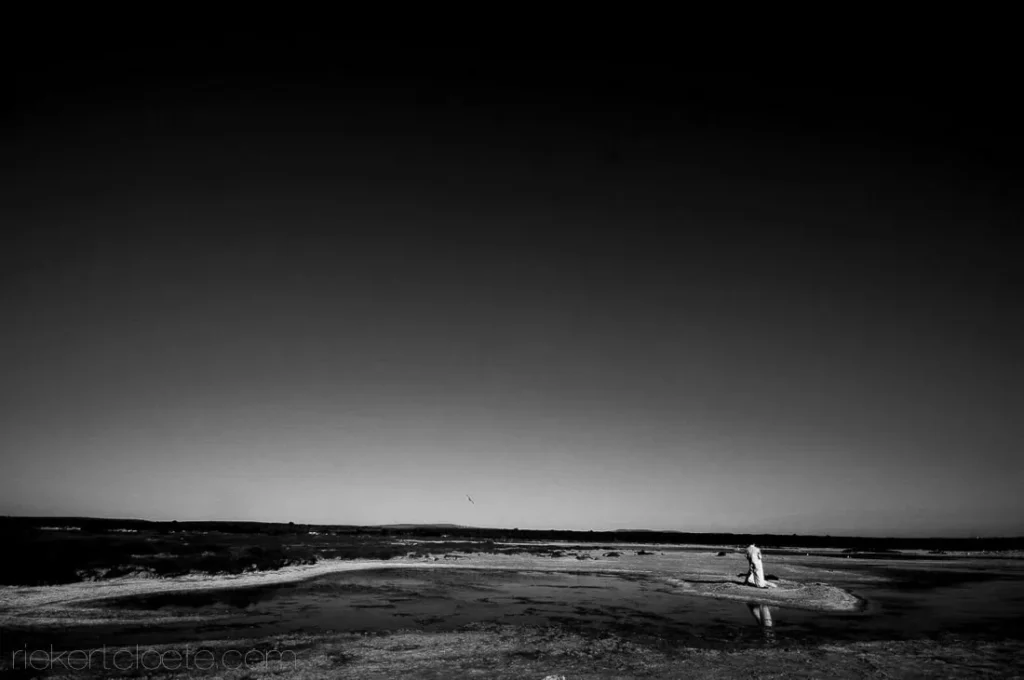 couple dusk vast lagoon saltpan landscape