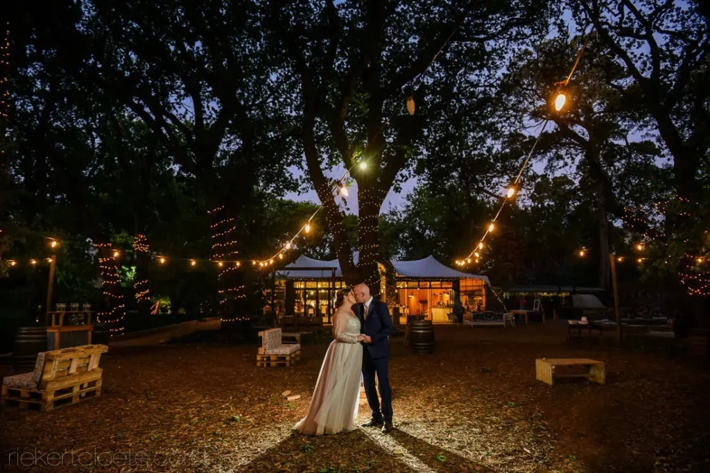 couple embrace eloftebos string lights dusk