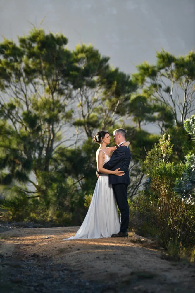 couple embrace fynbos hillside dusk mountain backdrop