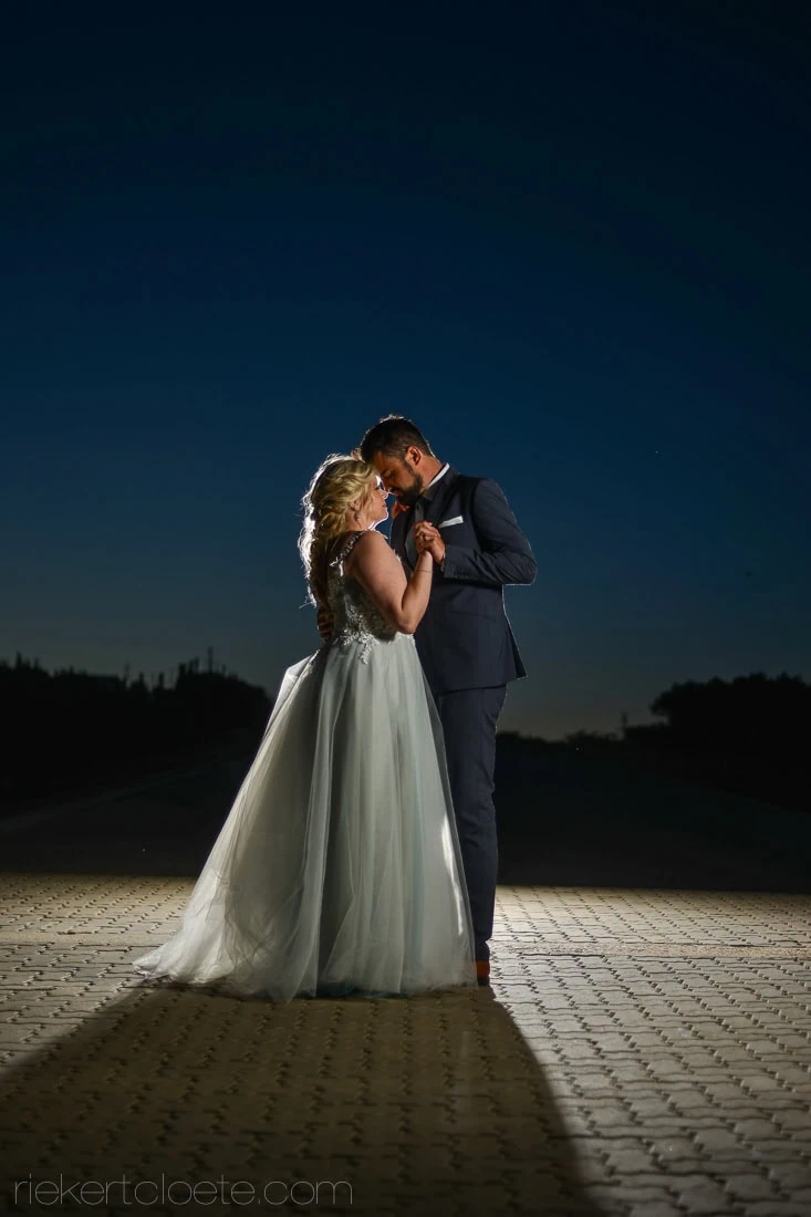 couple embrace night deep blue sky wedding