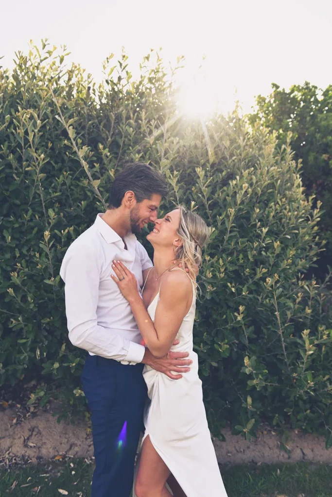 couple embracing garden hedge golden sunflare