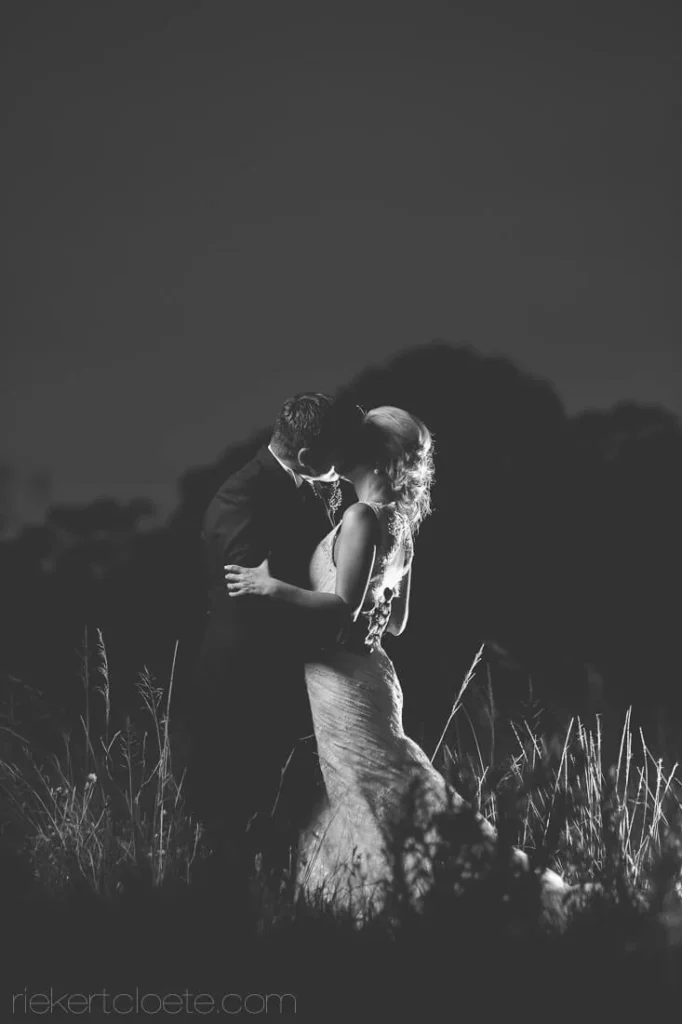 couple embracing tall grass field night portrait