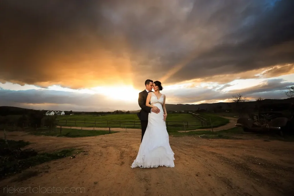 couple farm dirt road dramatic stormy sunset