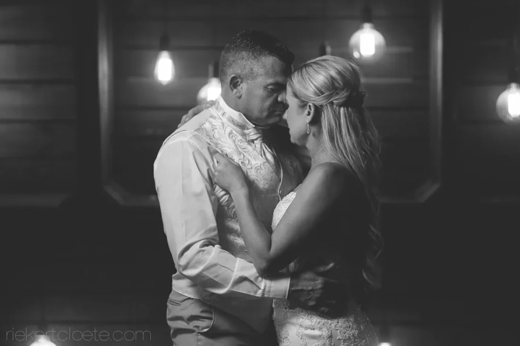 couple first dance rustic venue pendant lights
