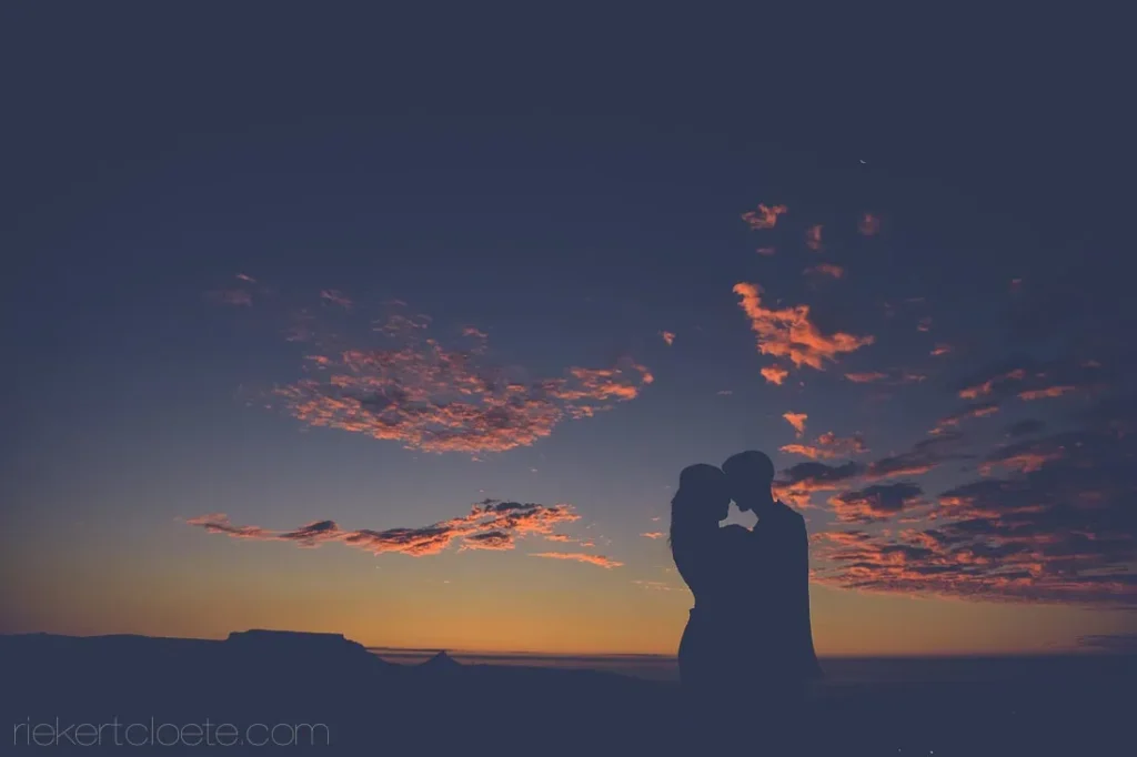 couple forehead touch bon amis fiery sunset
