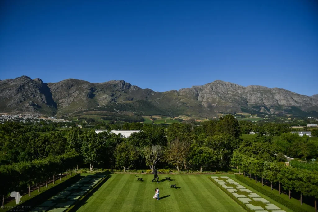 couple formal garden lawn franschhoek mountain backdrop