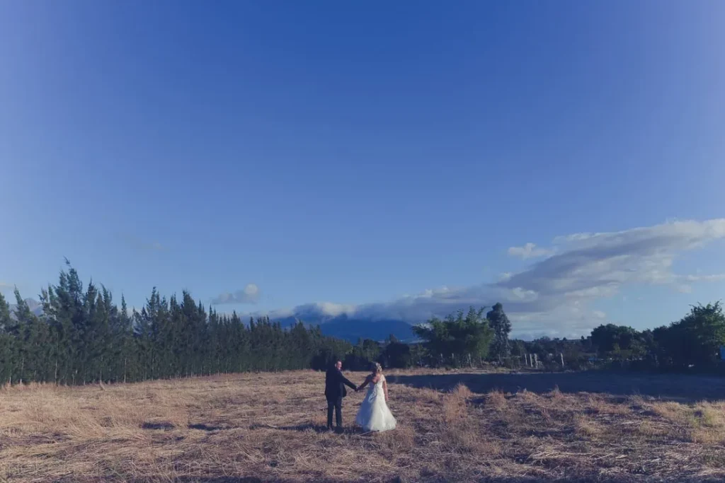 couple golden dry grass fields dusk mountain trees