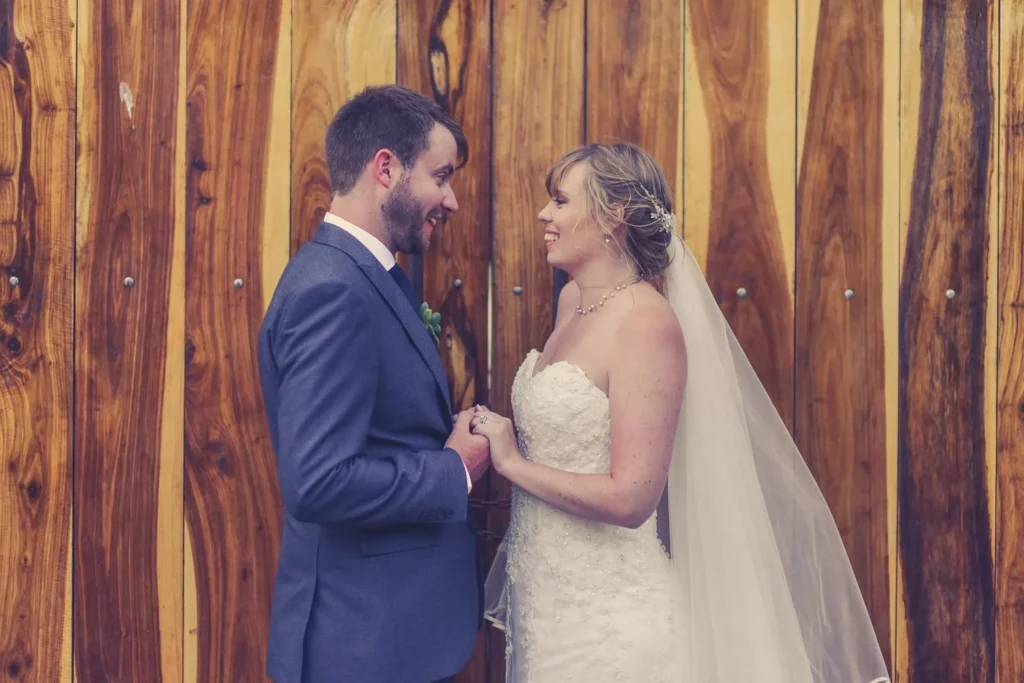 couple holding hands rustic wooden barn doors