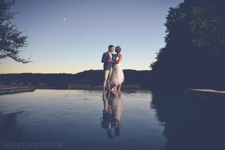 couple infinity pool dusk reflection moonrise