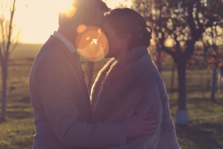 couple intimate golden hour kiss garden