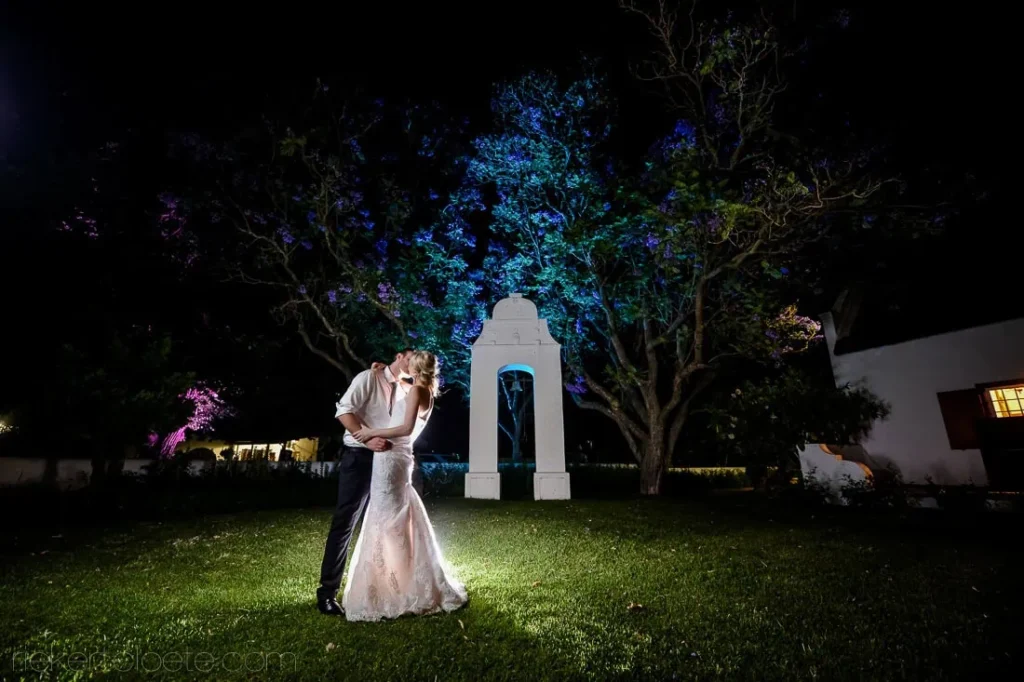 couple kiss cape dutch gable lit trees night