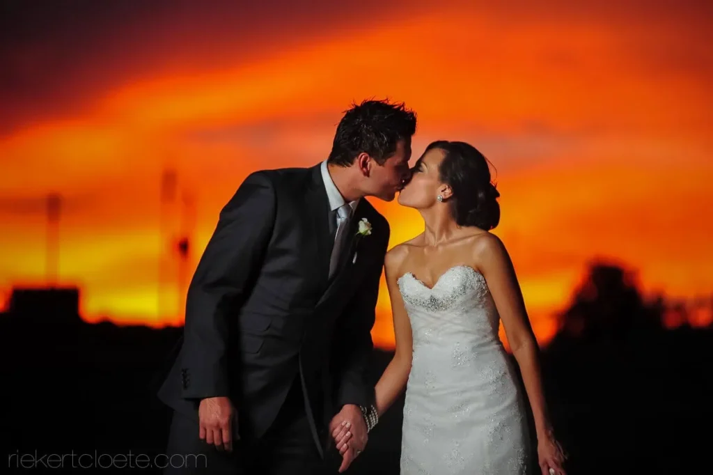 couple kiss fiery orange red sunset portrait