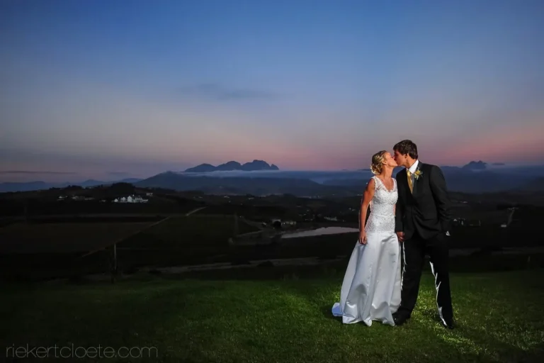 couple kiss vineyard estate lawn blue pink dusk