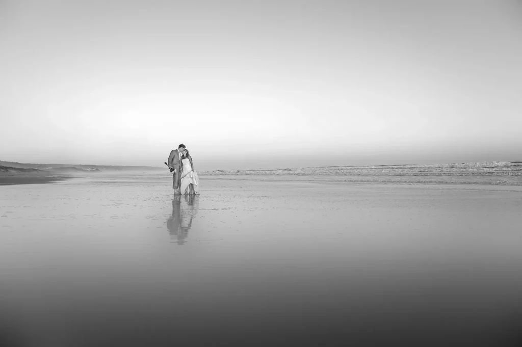 couple kissing beach ocean waves reflection