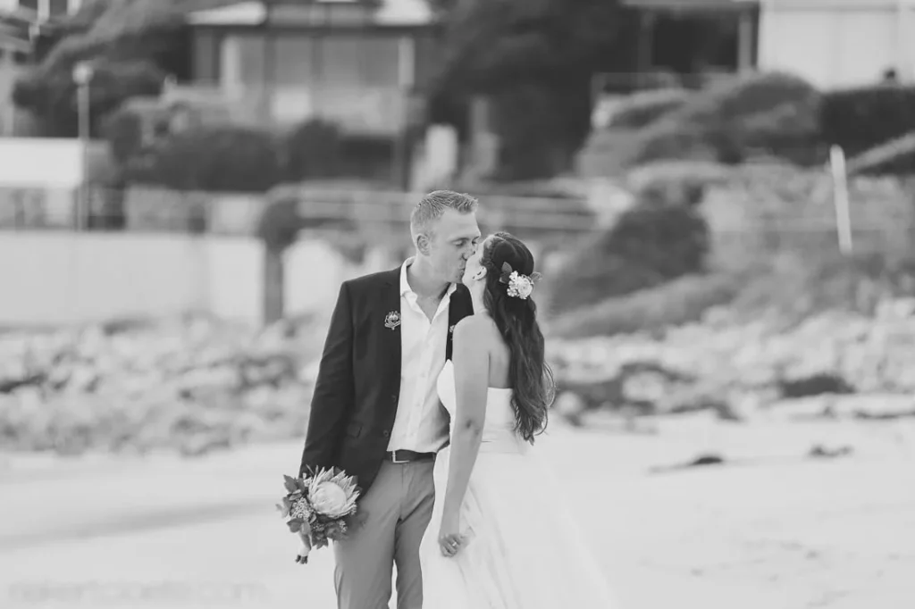 couple kissing cape town beach elopement bw