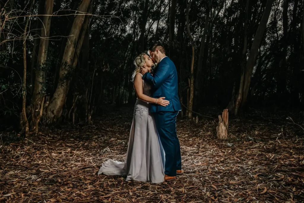 couple kissing eucalyptus forest golden autumn light