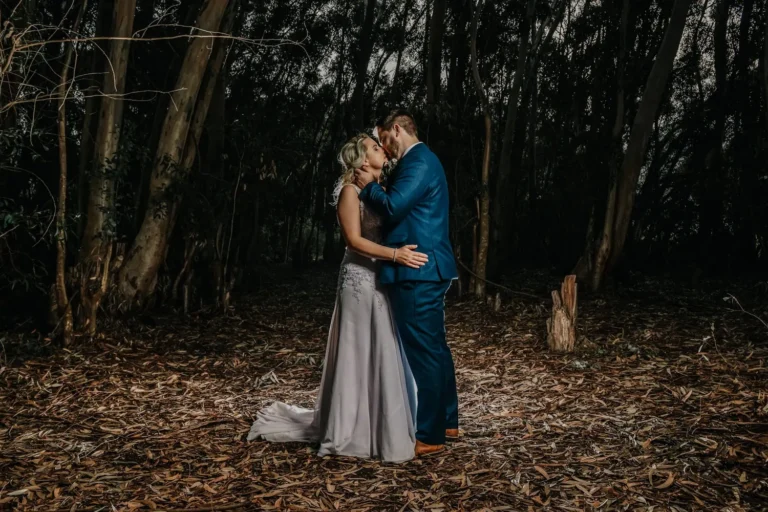 couple kissing eucalyptus forest golden autumn light