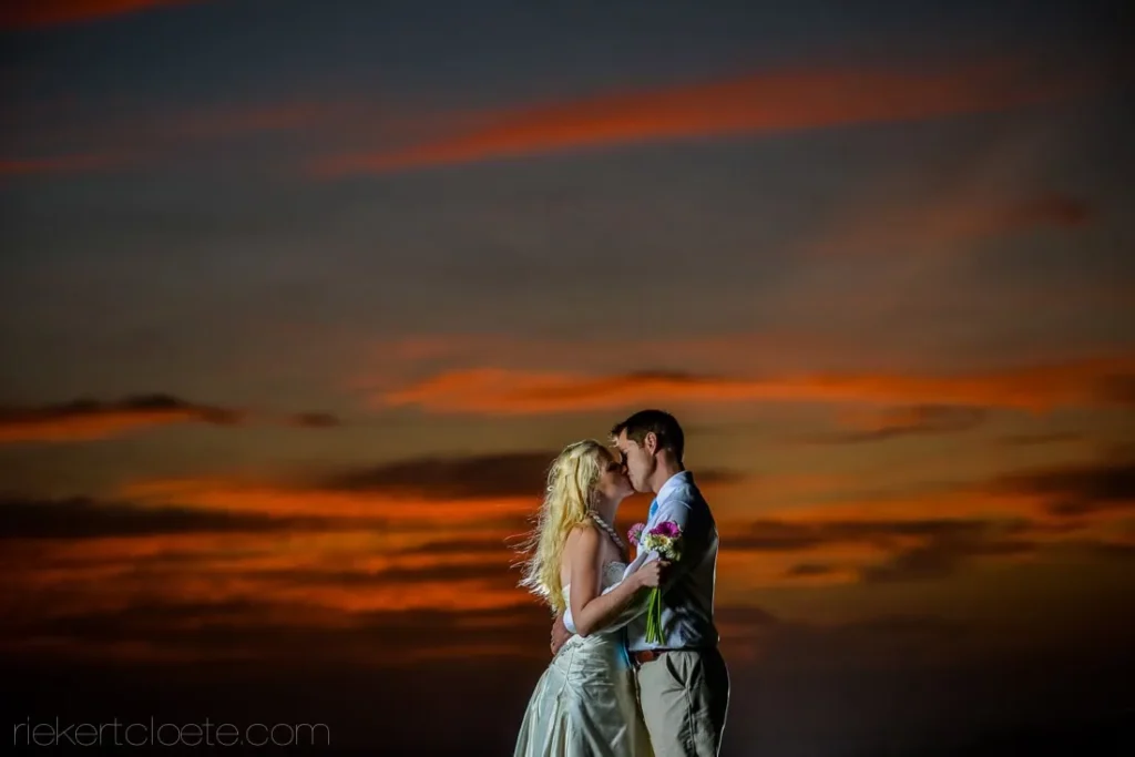 couple kissing fiery red orange sunset sky