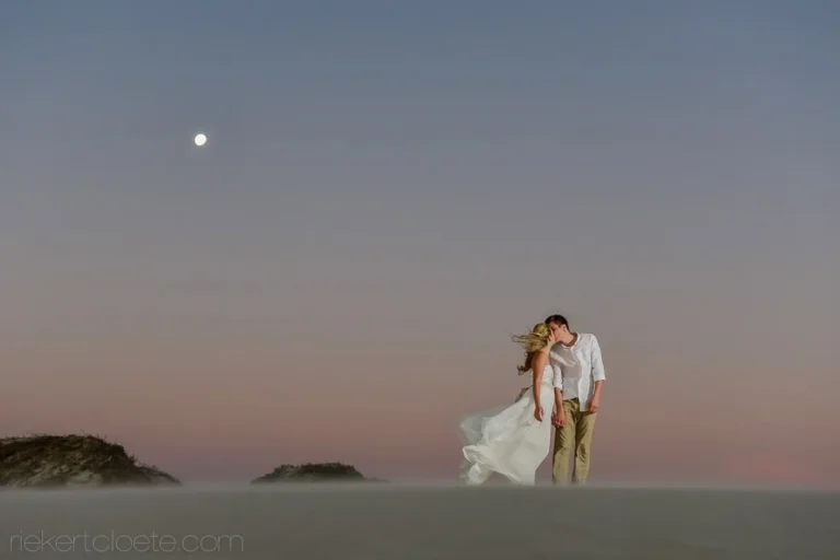 couple kissing misty beach full moon sand dunes