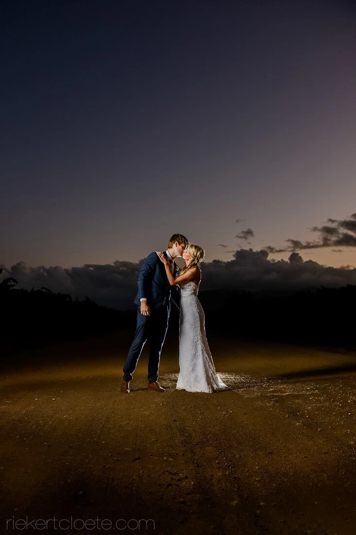 couple kissing night dusk sky open road wedding
