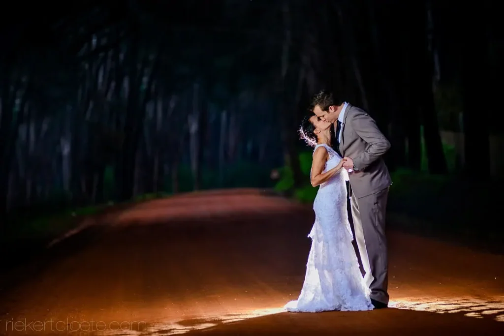 couple kissing pine forest red dirt road night