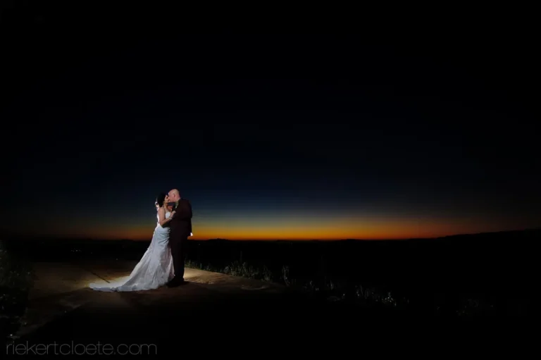 couple kissing ridge deep blue dusk panoramic view