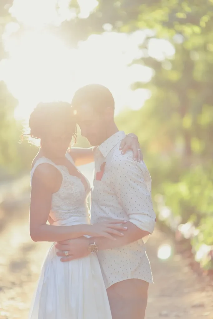 couple kissing sun flare dappled path western cape