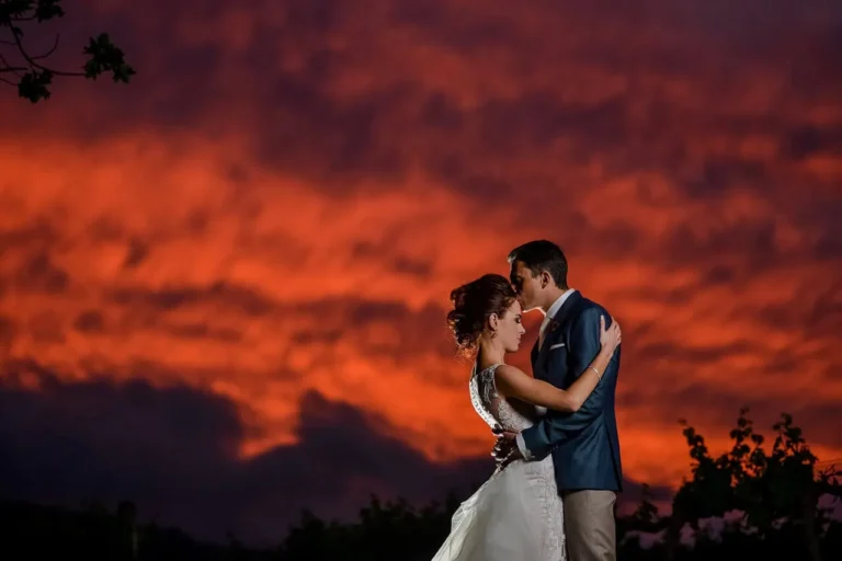 couple kissing vivid red sunset cloudscape