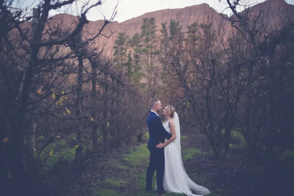 couple kissing winter fruit orchard red mountain