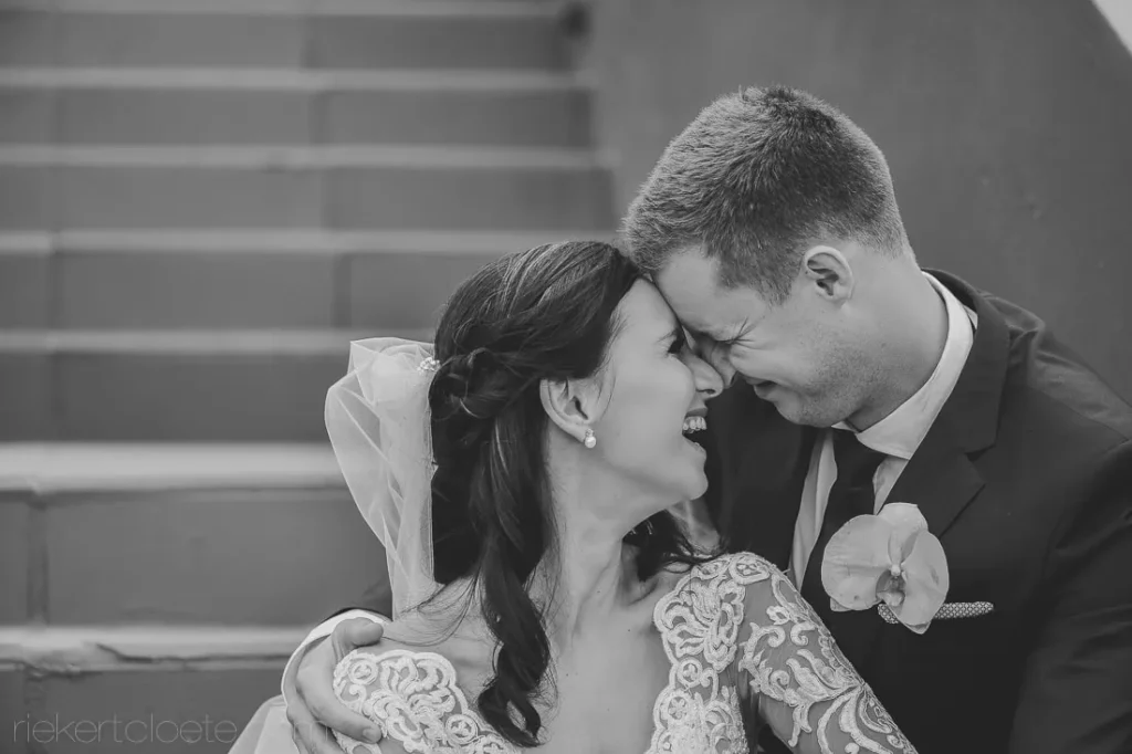 couple laughing stone stairs lace gown portrait