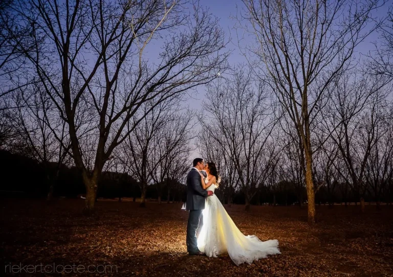 couple night portrait orchard bare winter trees