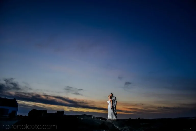 couple rocks dramatic dusk coastal wedding