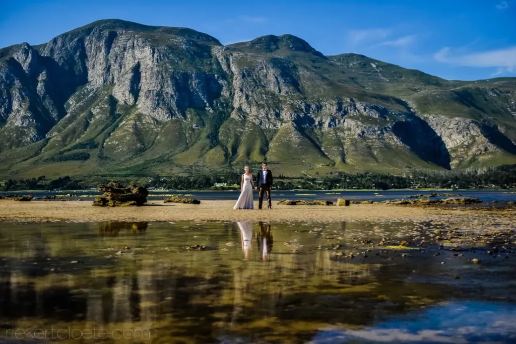 couple rocky shoreline dramatic mountains tidal reflection