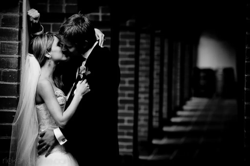 couple romantic moment brick corridor bw portrait