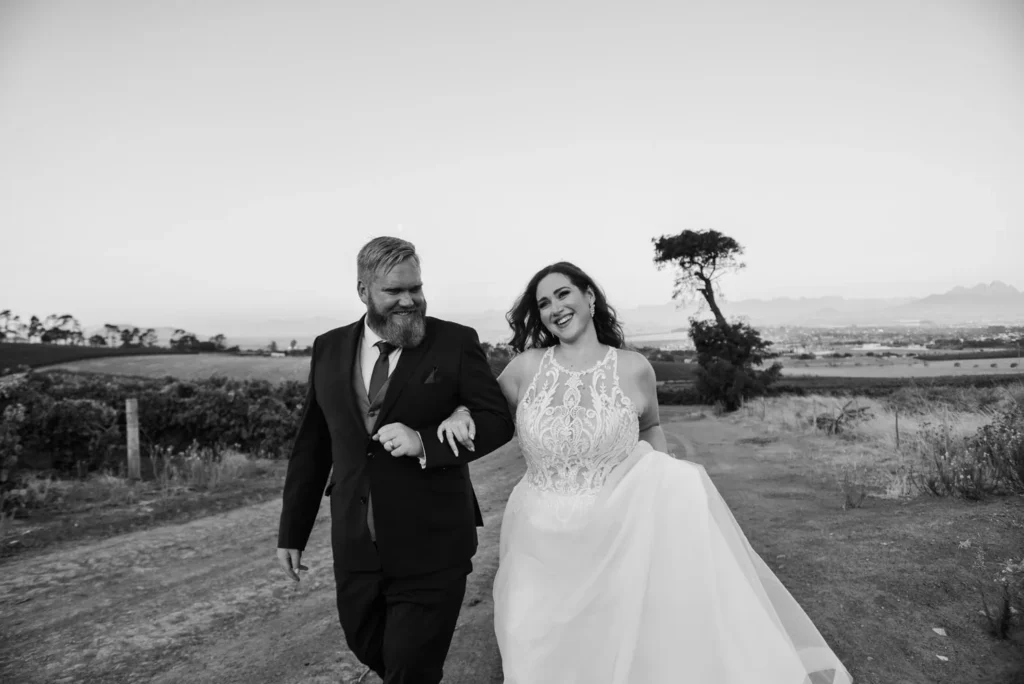 couple running farm road mountain landscape black white