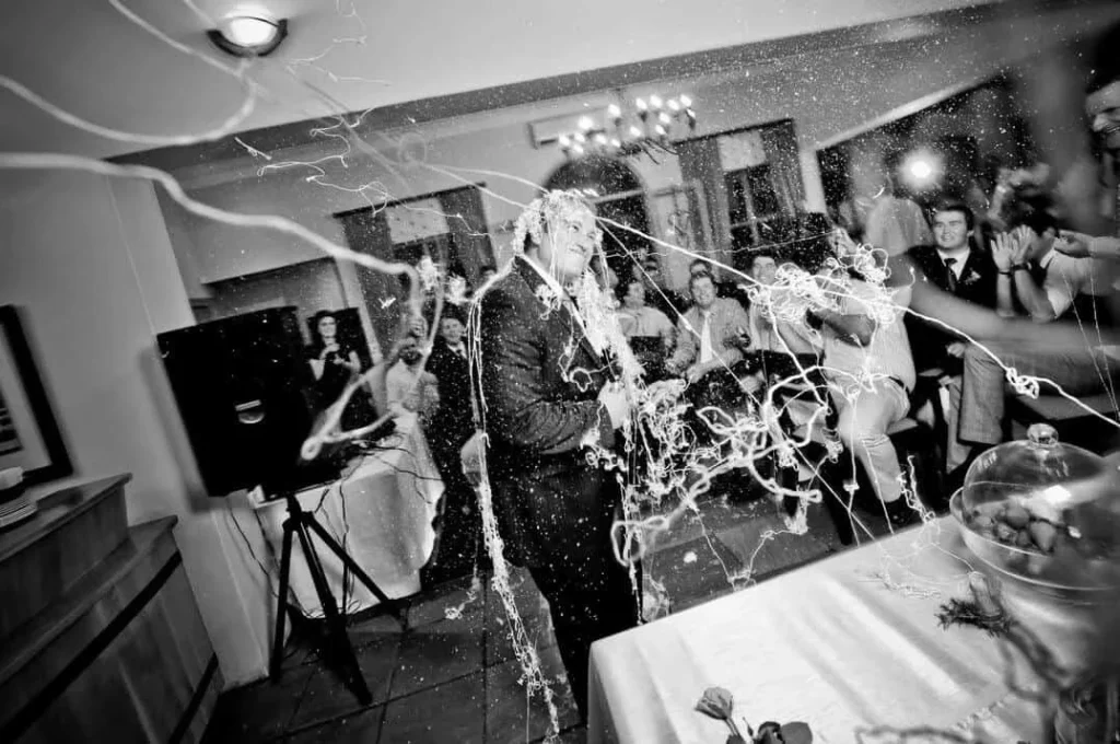 couple showered streamers wedding reception celebration